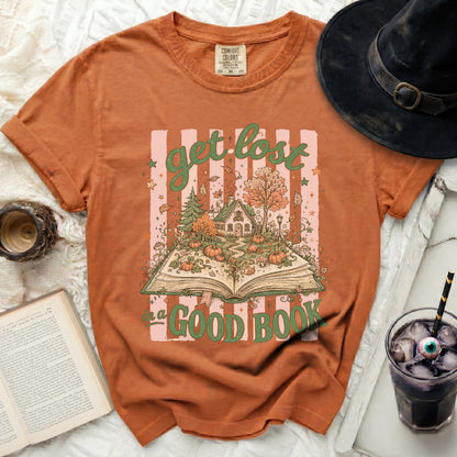 Orange t-shirt with "get lost in a good book" Halloween graphic.