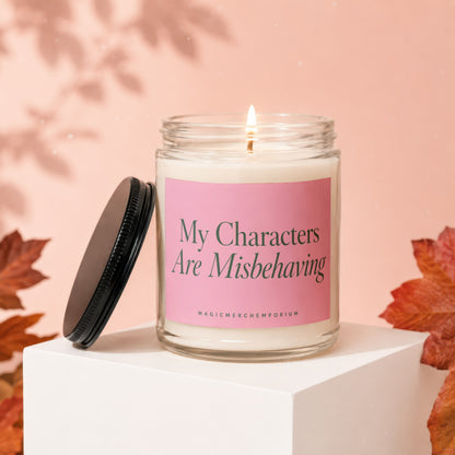 Candle with "My Characters Are Misbehaving" text on a pink label.