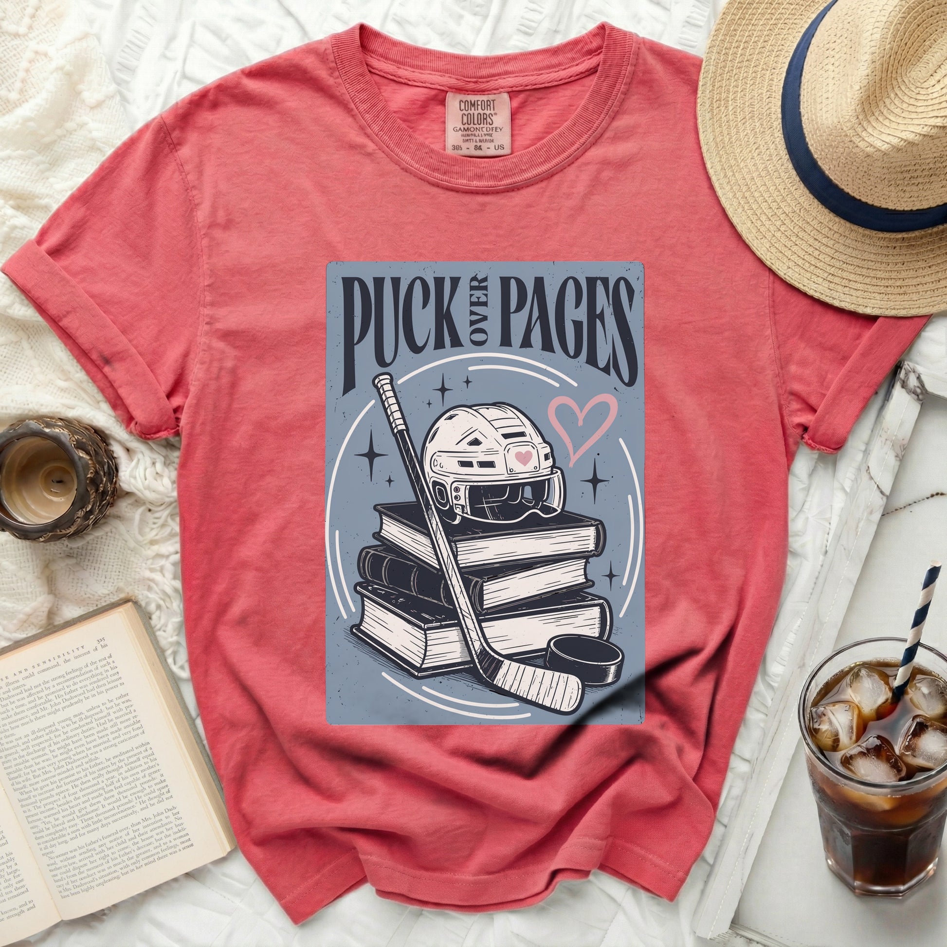 T-shirt with hockey gear and "Puck Pages" text.