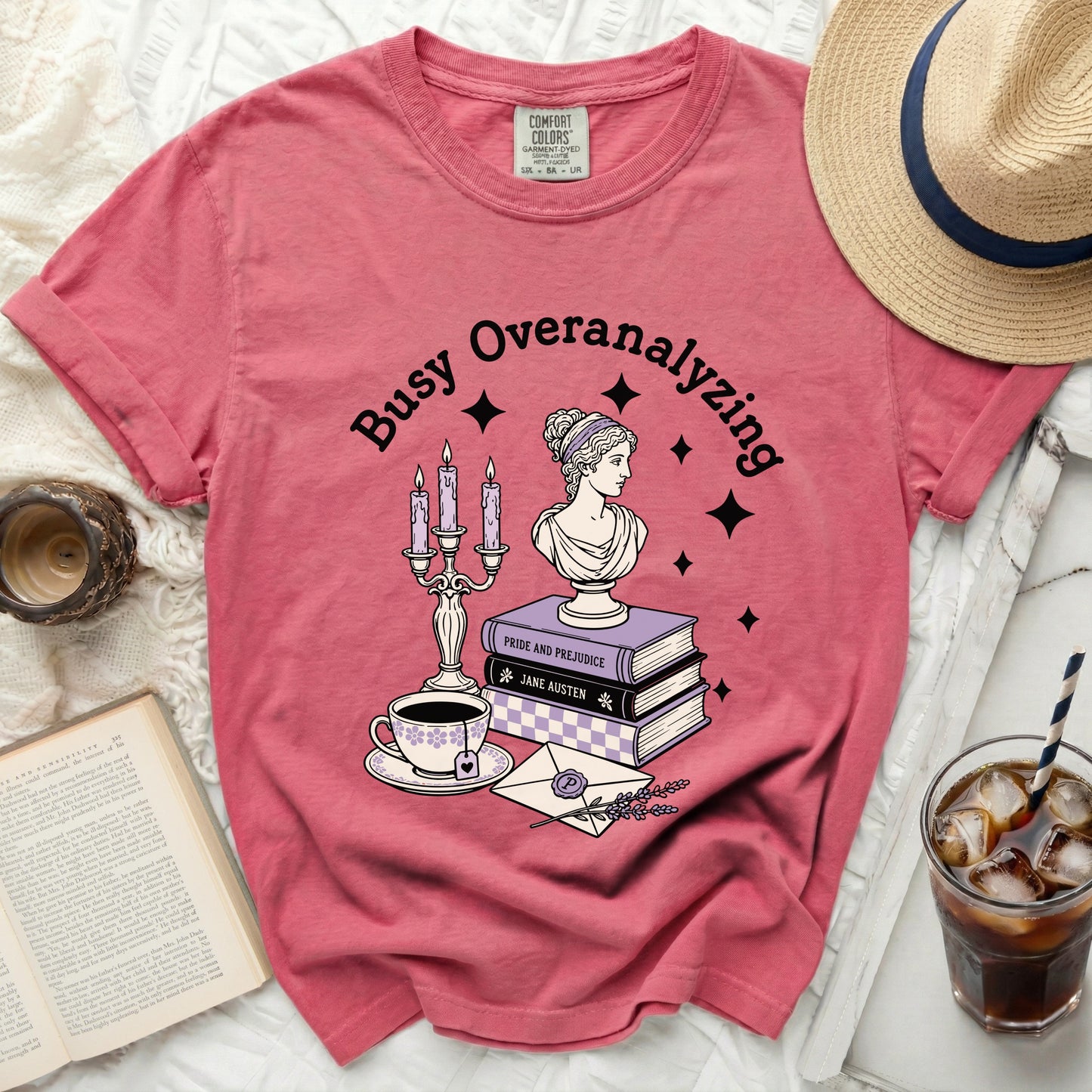 Pink t-shirt with "Busy Overanalyzing" and literary-themed graphic.