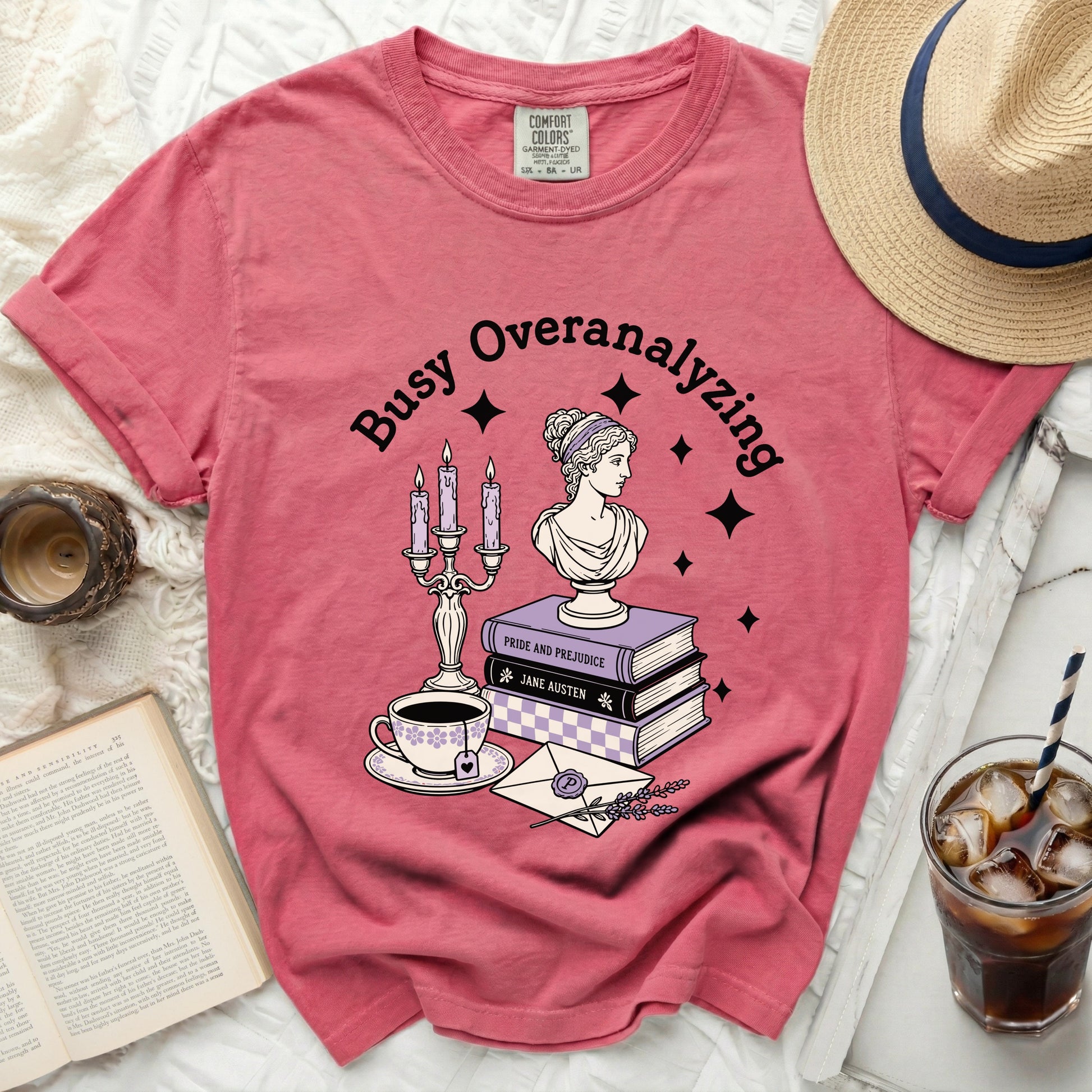 Pink t-shirt with "Busy Overanalyzing" and literary-themed graphic.