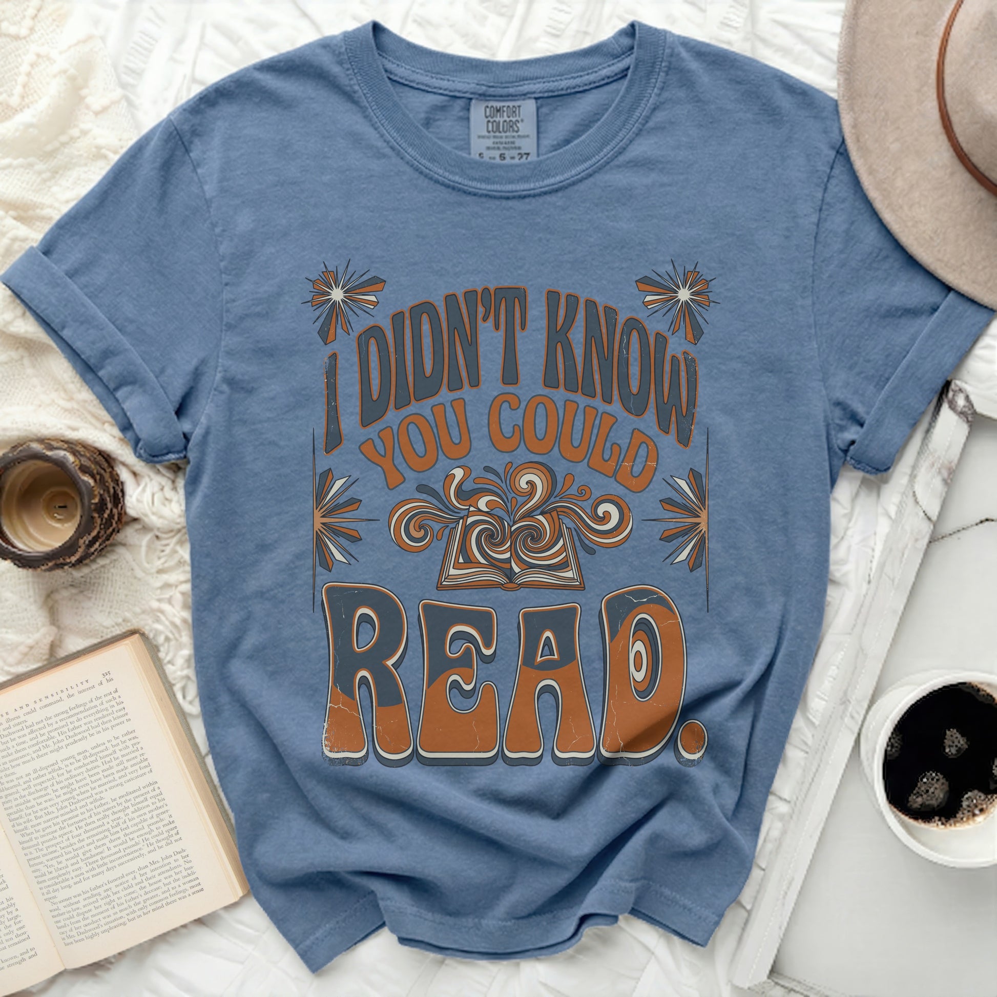 Blue t-shirt with "I didn't know you could read" text and open book graphic.