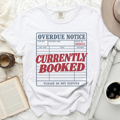 White t-shirt with "OVERDUE NOTICE CURRENTLY BOOKED PLEASE DO NOT DISTURB" graphic.