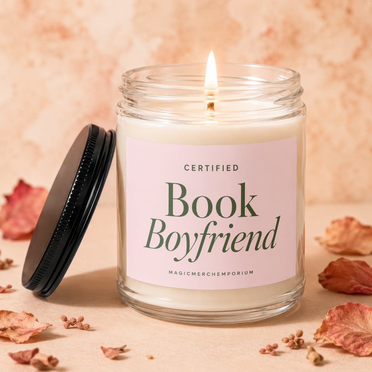 Glass jar candle with lit wick, reading "Certified Book Boyfriend".