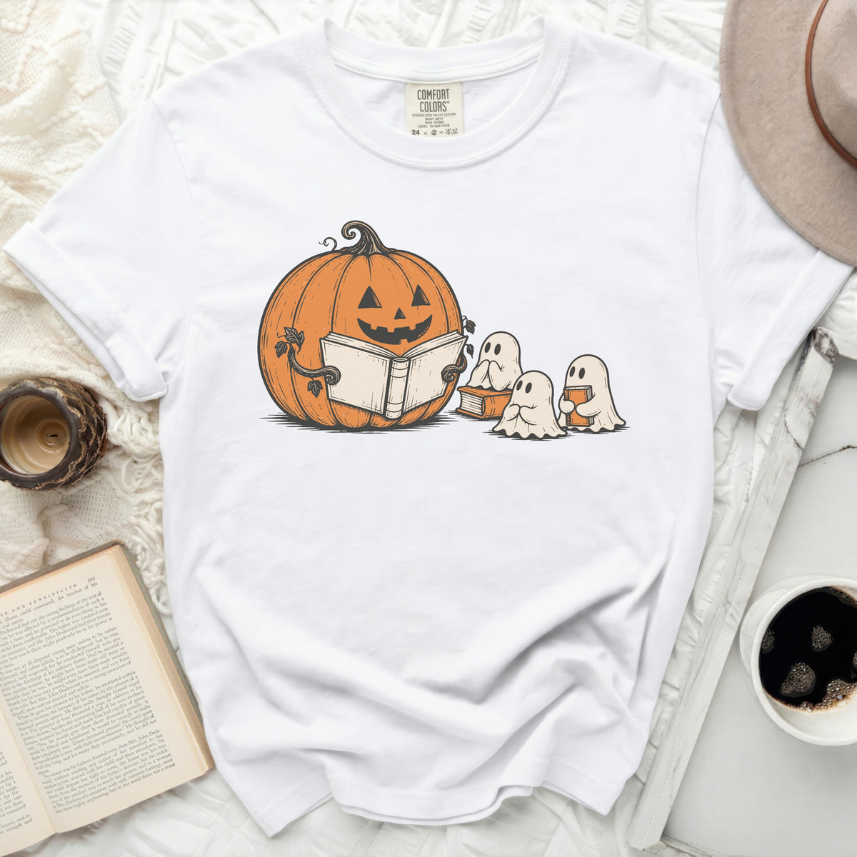 White t-shirt with a pumpkin reading to ghosts graphic.