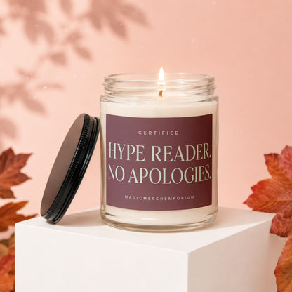 Candle with text "Certified Hype Reader. No Apologies." on a pink background.