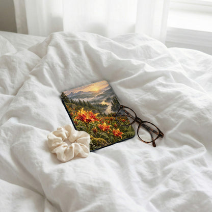 Coaster with floral landscape, scrunchie, and glasses on rumpled white sheets.