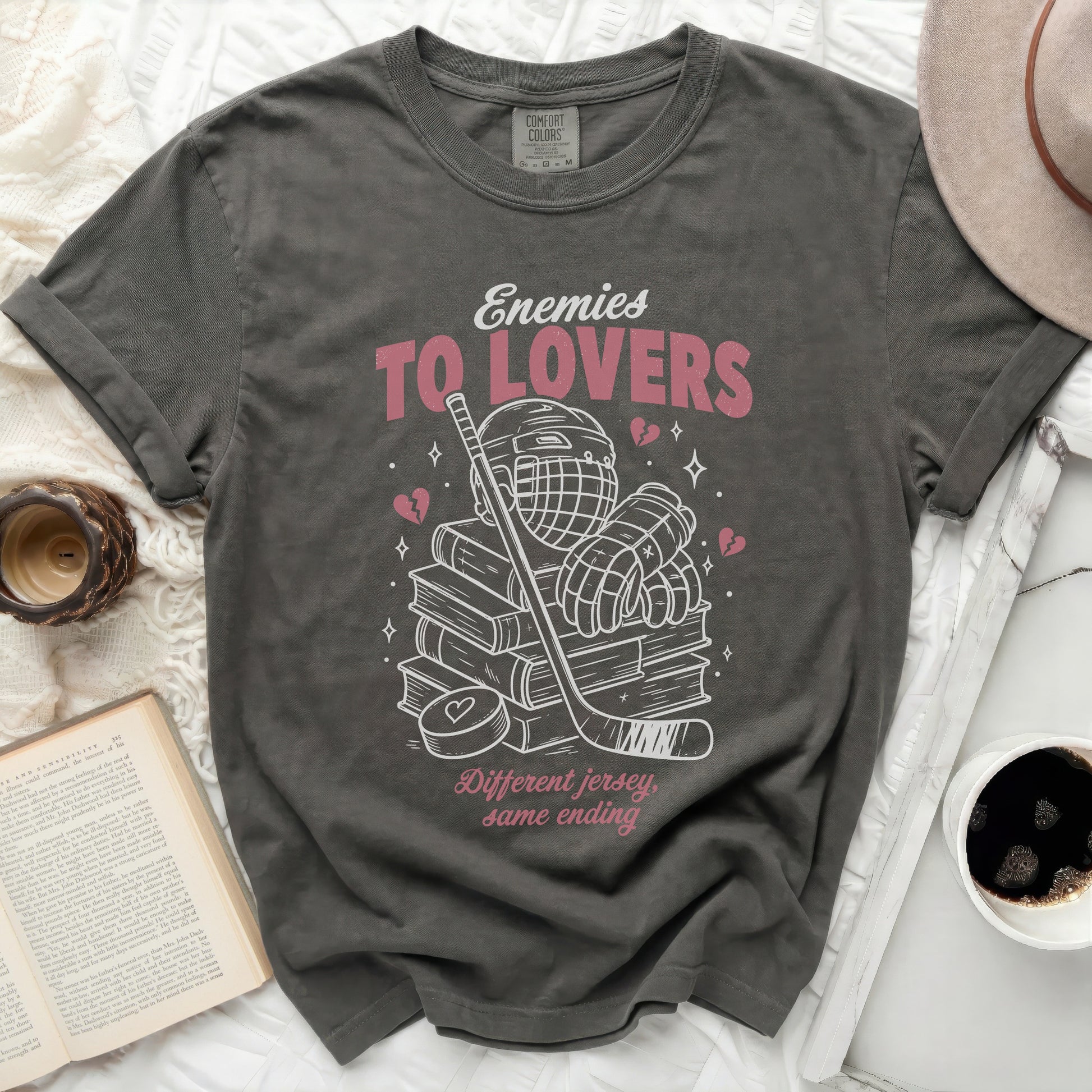 Dark t-shirt with "Enemies To Lovers" and hockey graphics.