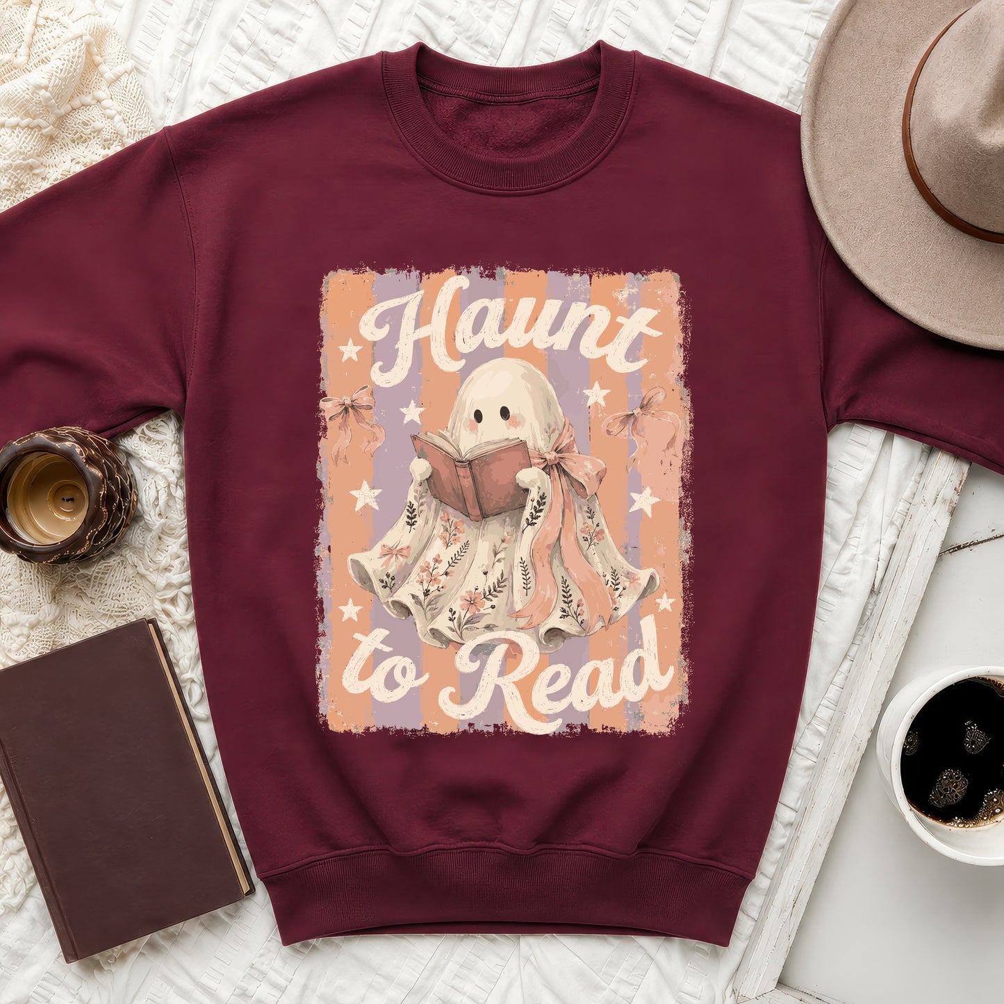 Maroon sweatshirt with "Haunt to Read" text and cute ghost graphic.