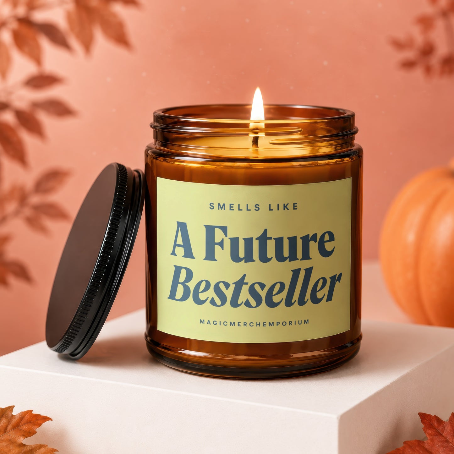 Lit amber candle with a black lid, reading "Smells Like A Future Bestseller".