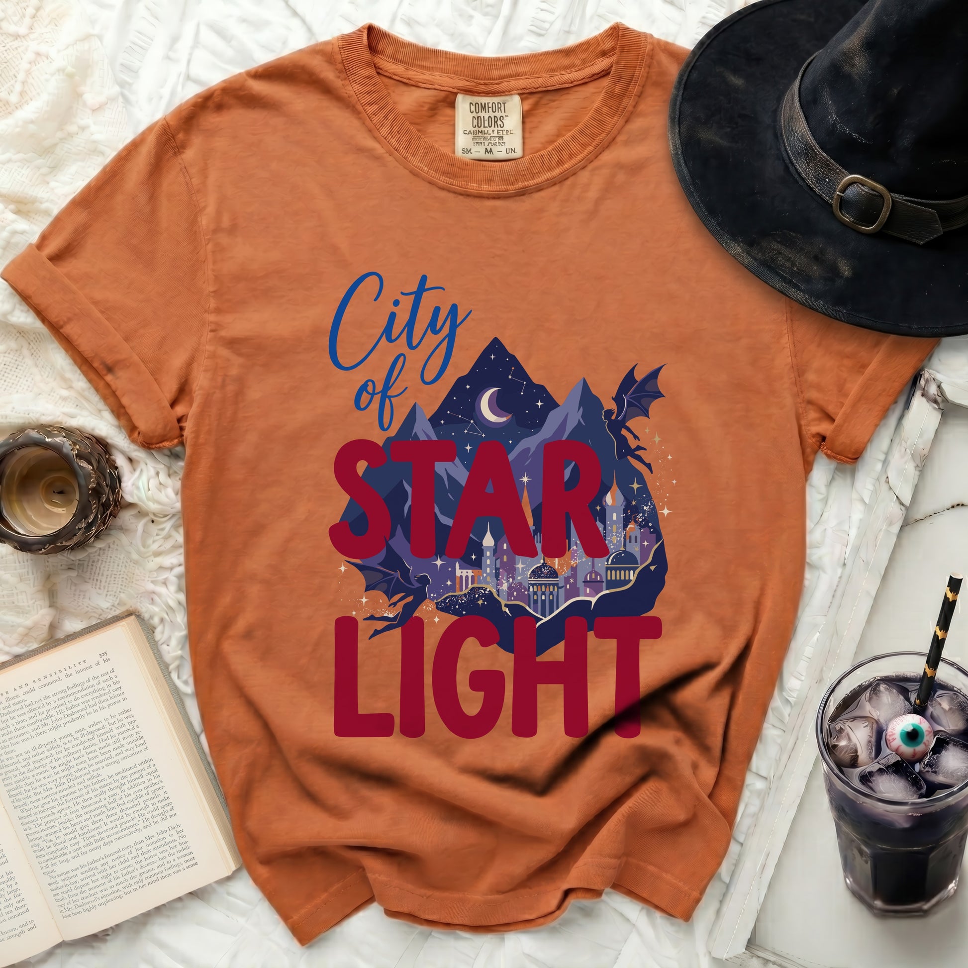 Orange t-shirt with "City of Star Light" graphic and dragon.
