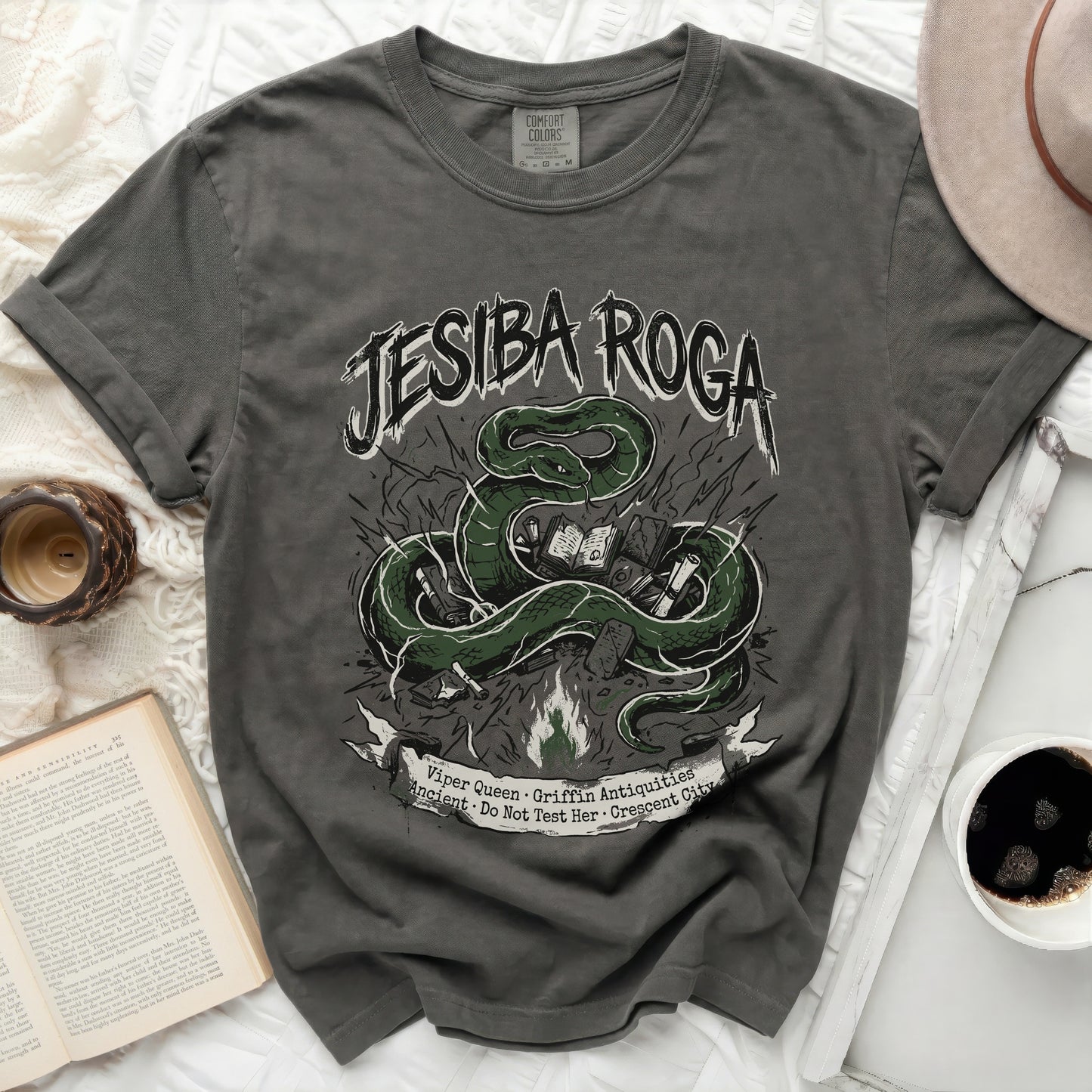 Grey t-shirt with green snake and book graphic and text.