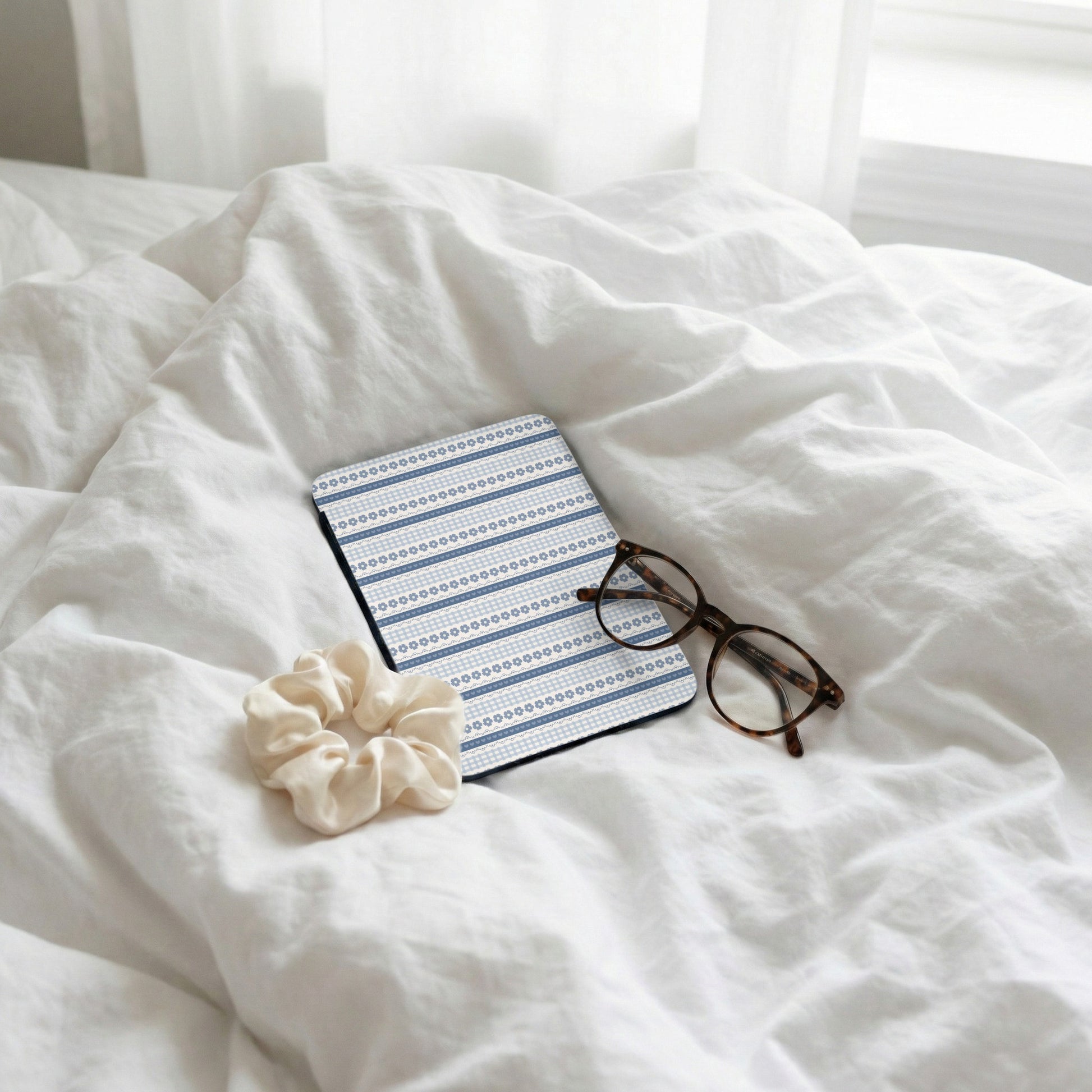 Blue and White Patterned Notebook on Bed Scene