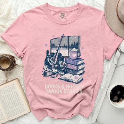 Pink t-shirt with books, hockey gear, and "Books & Hockey Swoon Stories" text.