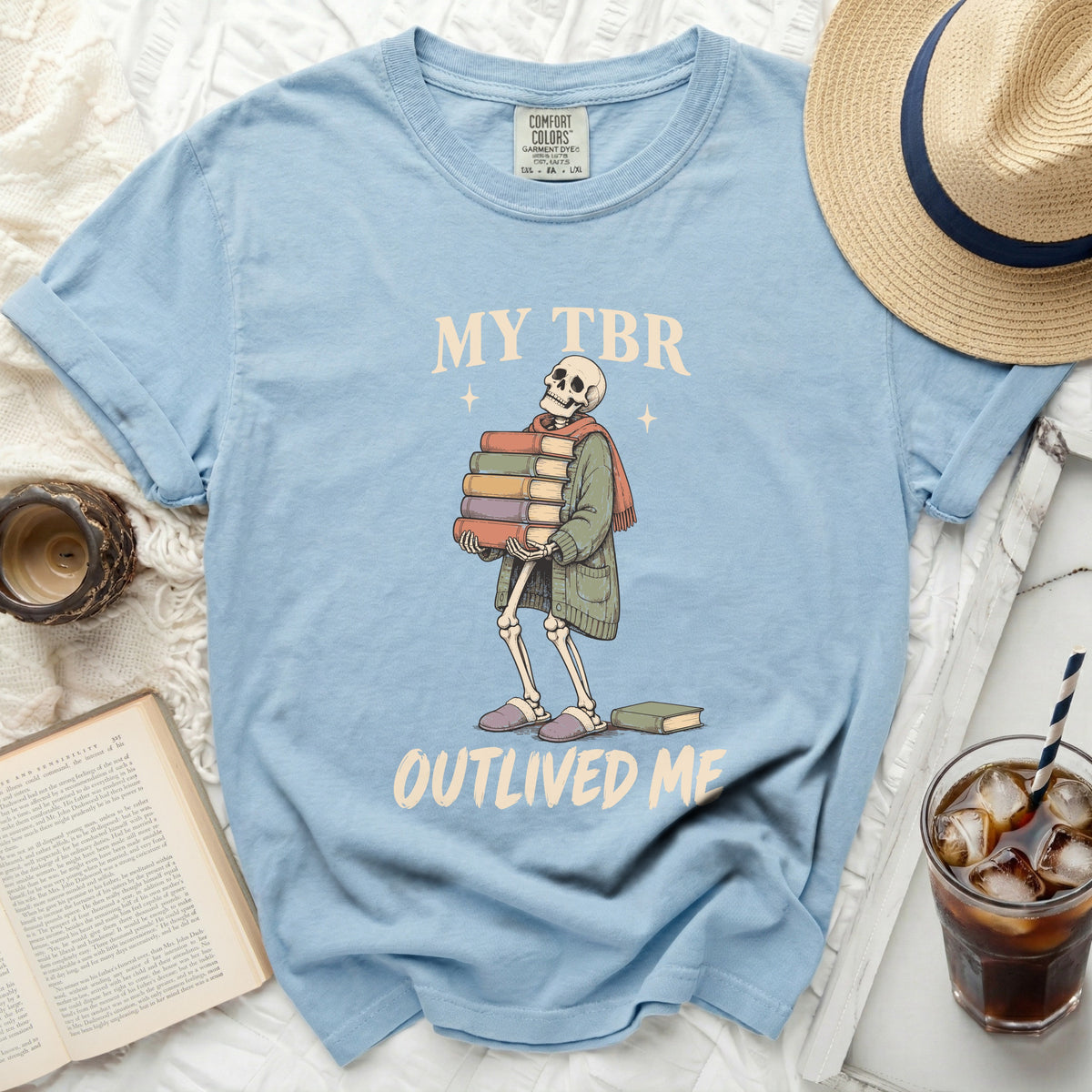 Light blue t-shirt with skeleton graphic and "MY TBR OUTLIVED ME" text.
