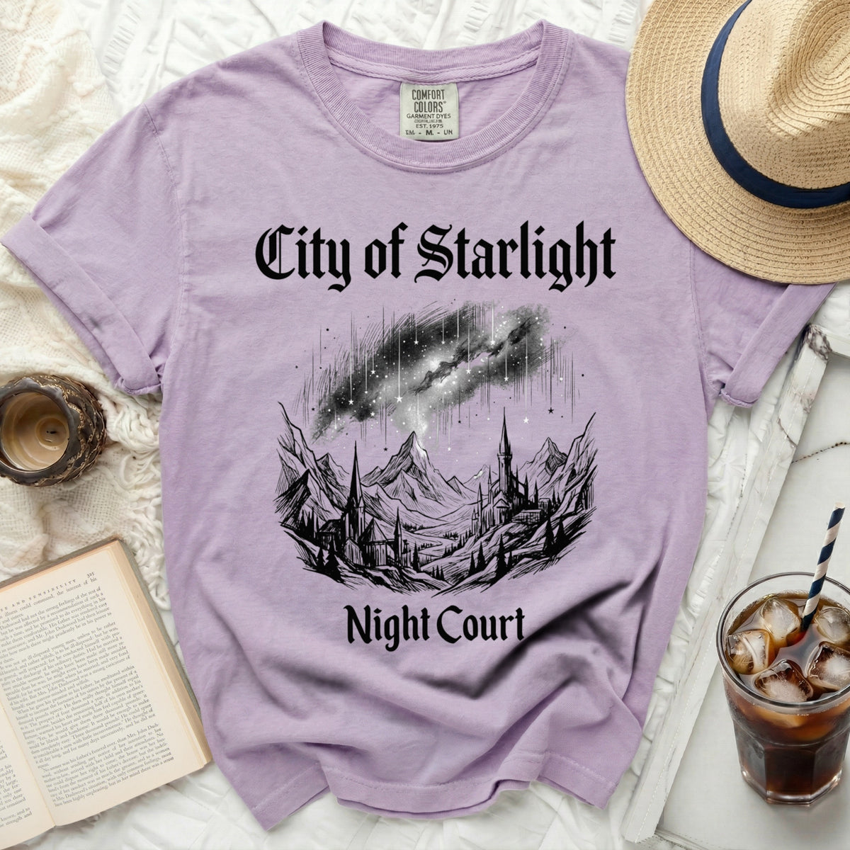 Purple t-shirt with "City of Starlight Night Court" text and celestial mountain graphic.