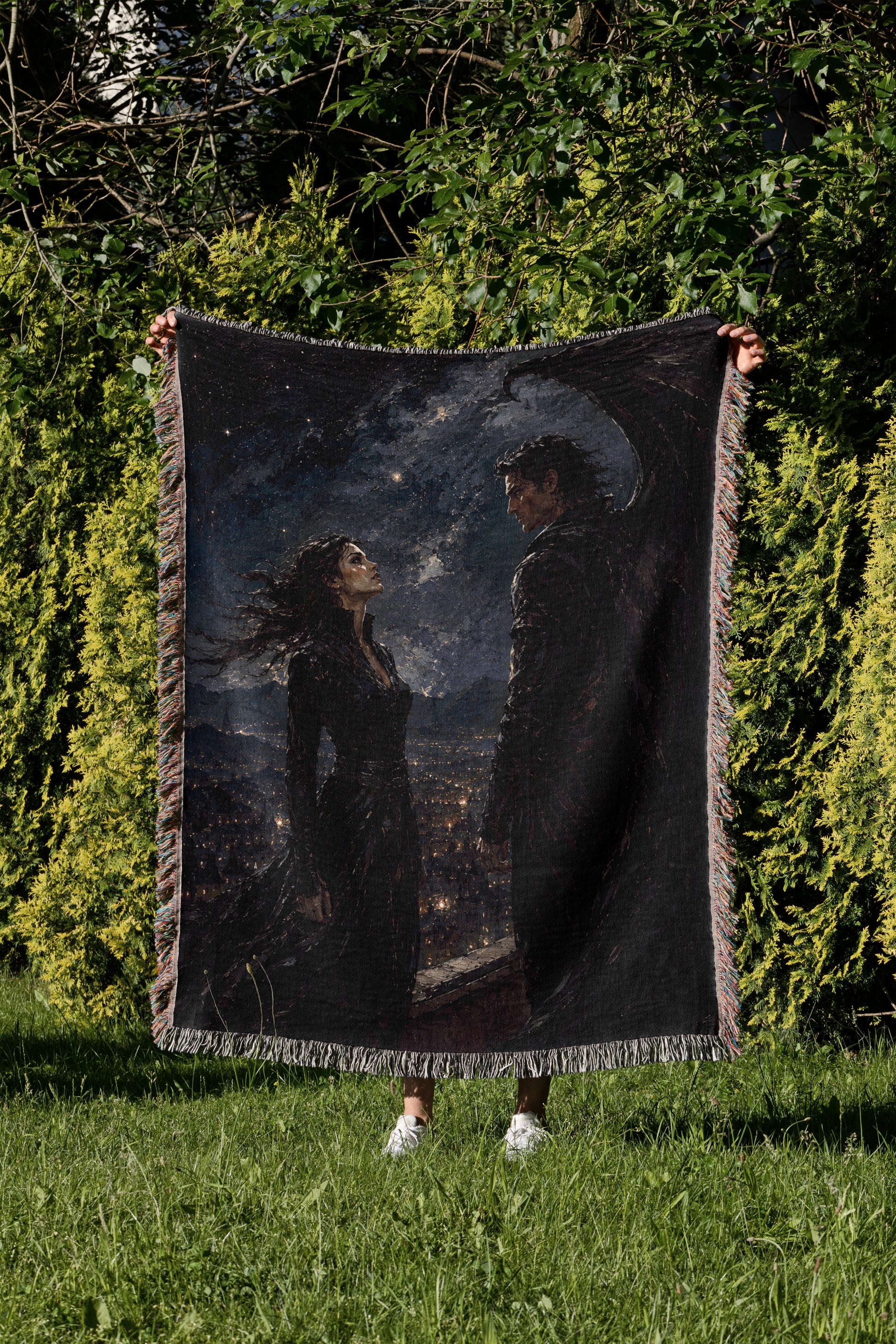 A person is holding up a large, framed tapestry depicting a woman and a man standing in a nighttime cityscape.