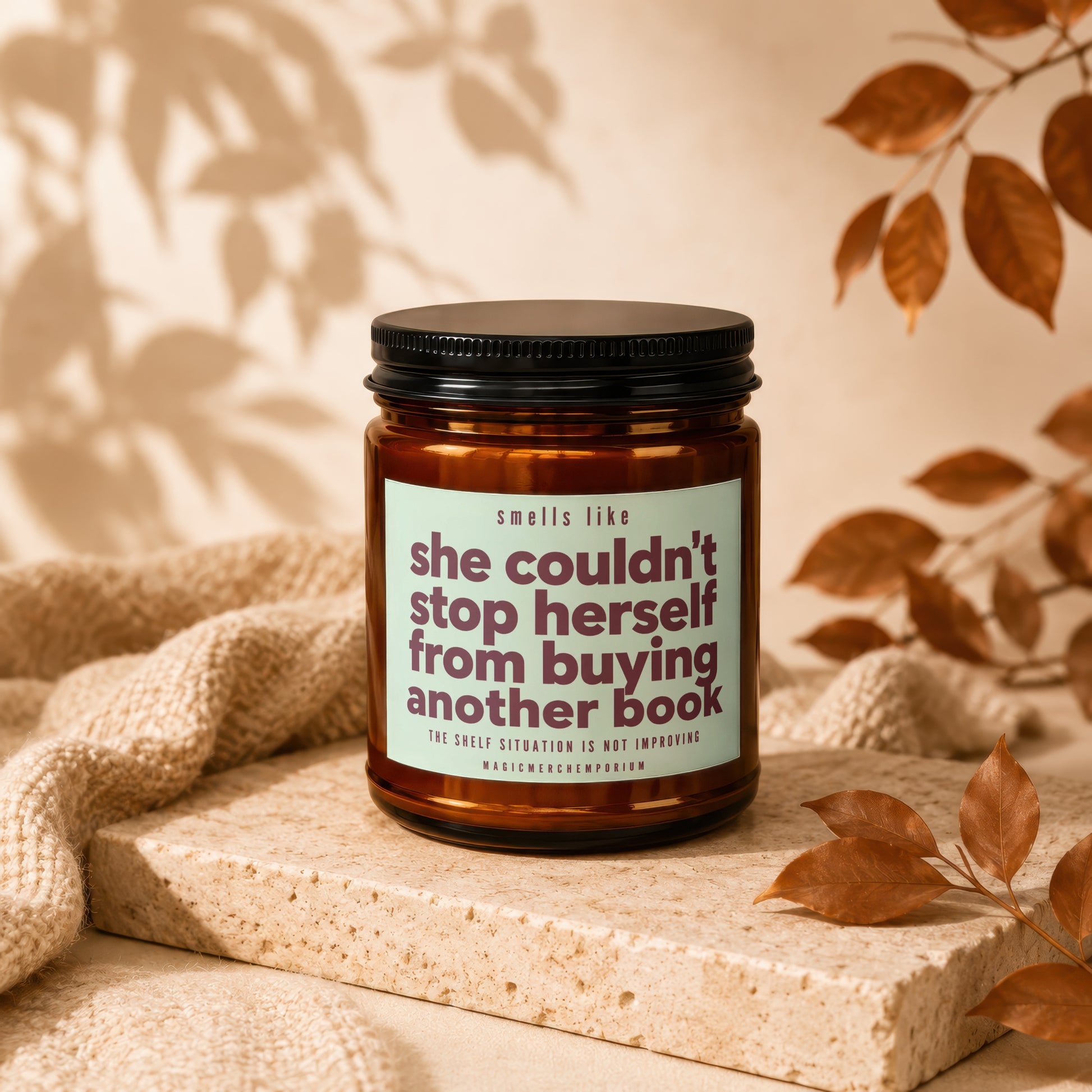 Amber candle with label text "she couldn't stop herself from buying another book".