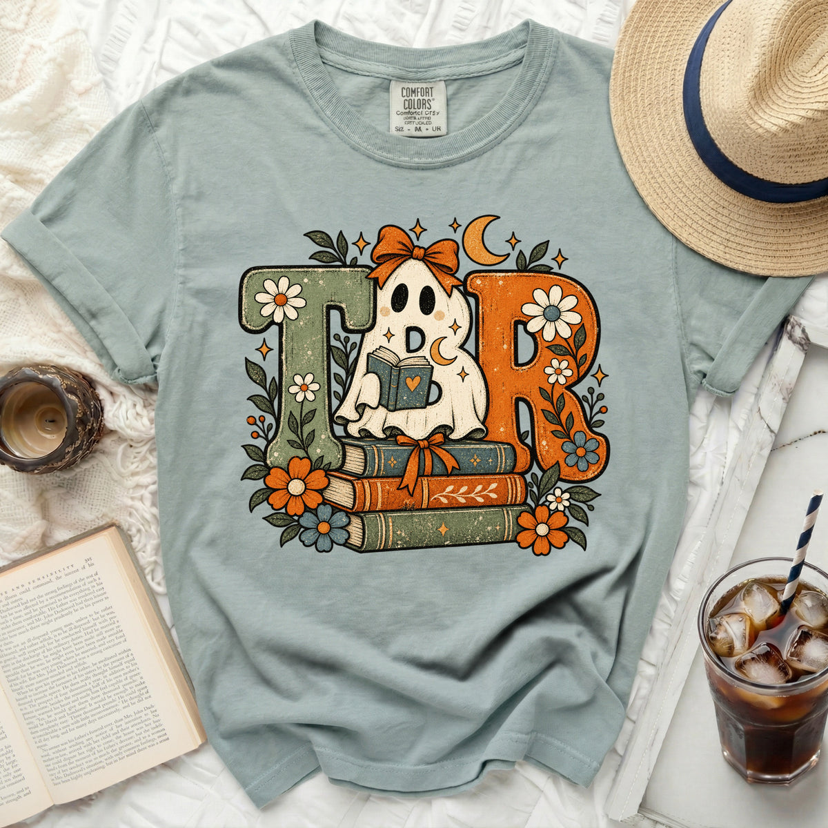 TBR ghost reading books t-shirt with floral and celestial accents.