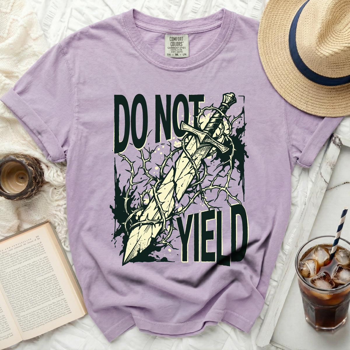 Purple t-shirt with sword and thorns graphic reading "DO NOT YIELD".