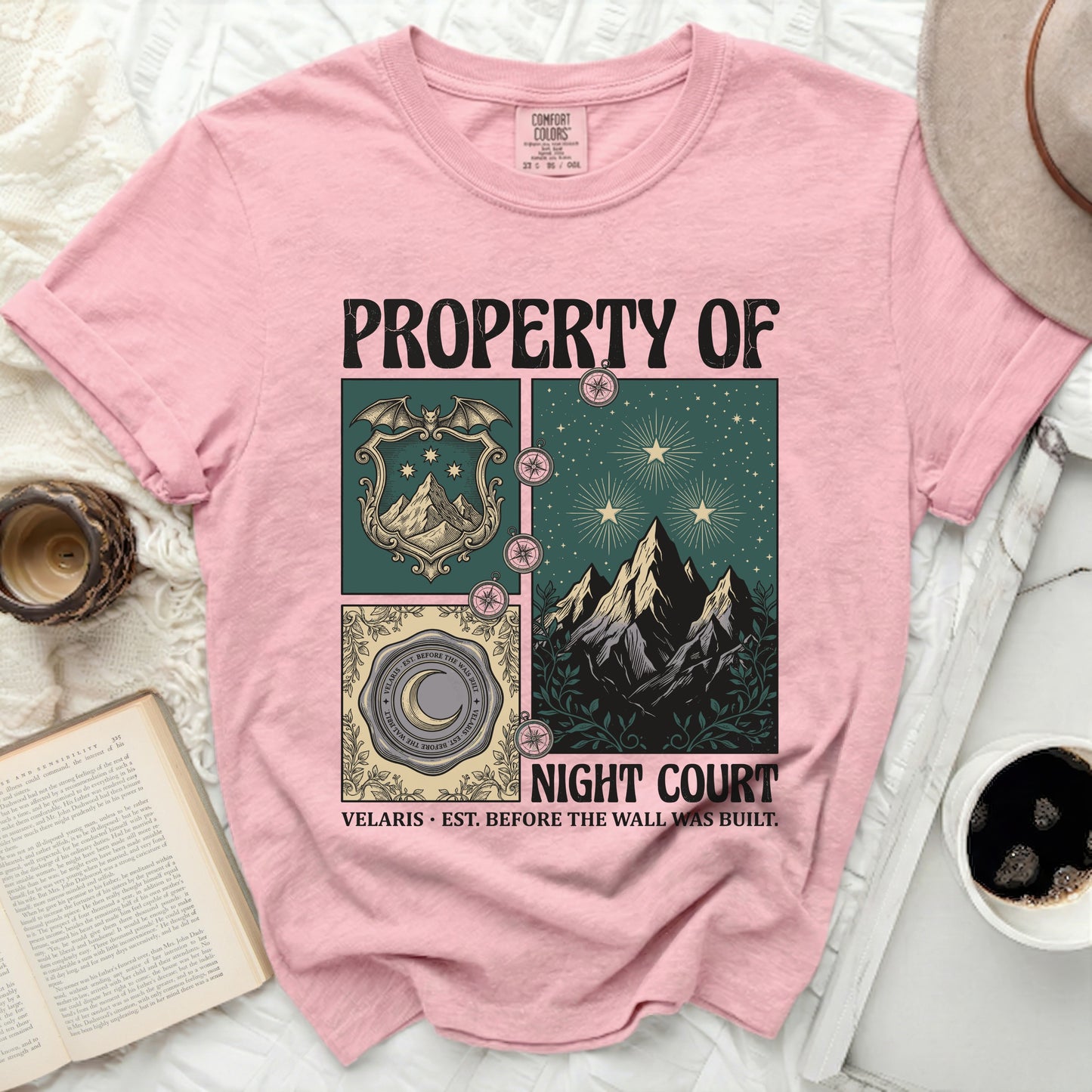 Pink Comfort Colors t-shirt with "Property of Night Court" and a crest with mountains.
