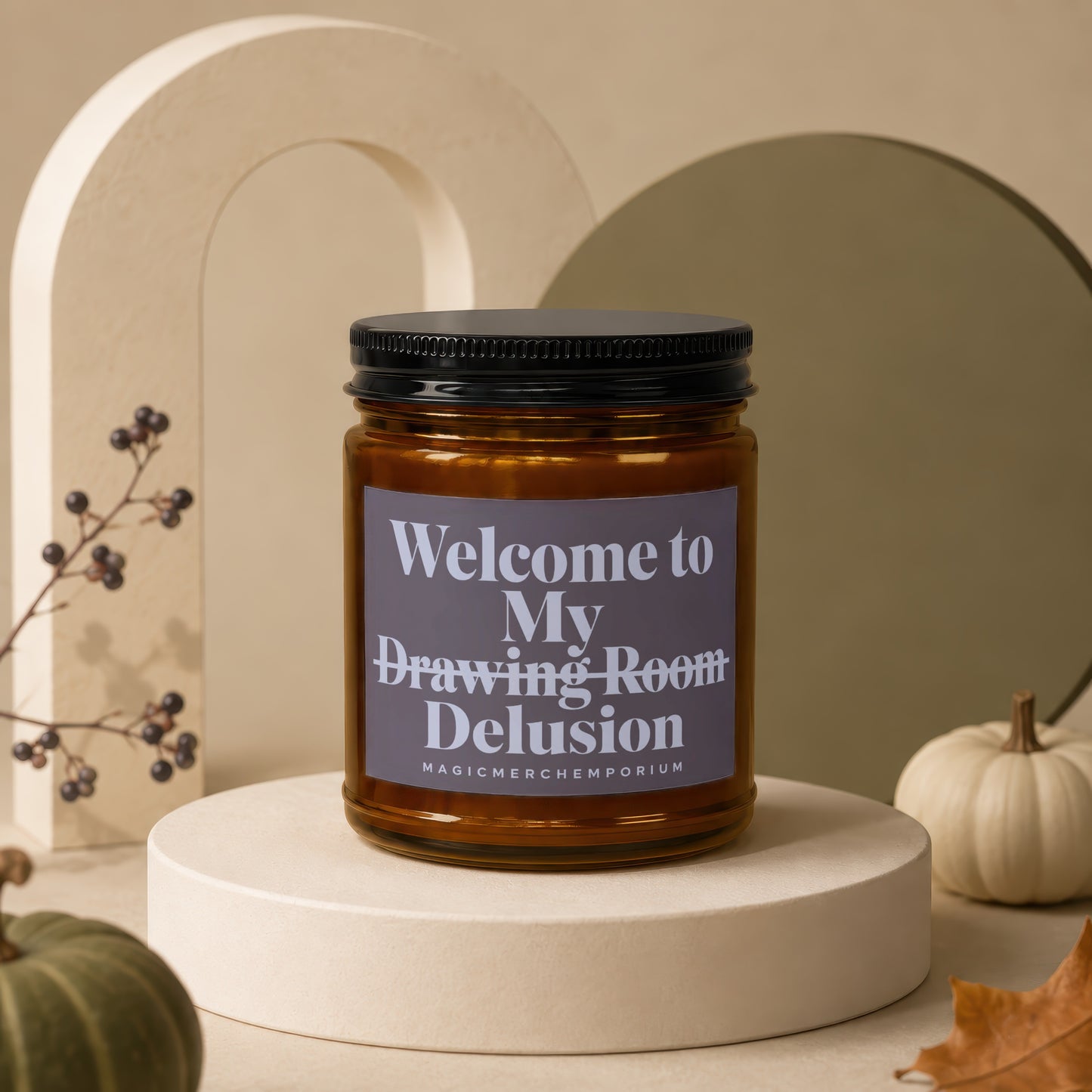 Amber candle jar with black lid reading "Welcome to My Drawing Room Delusion".
