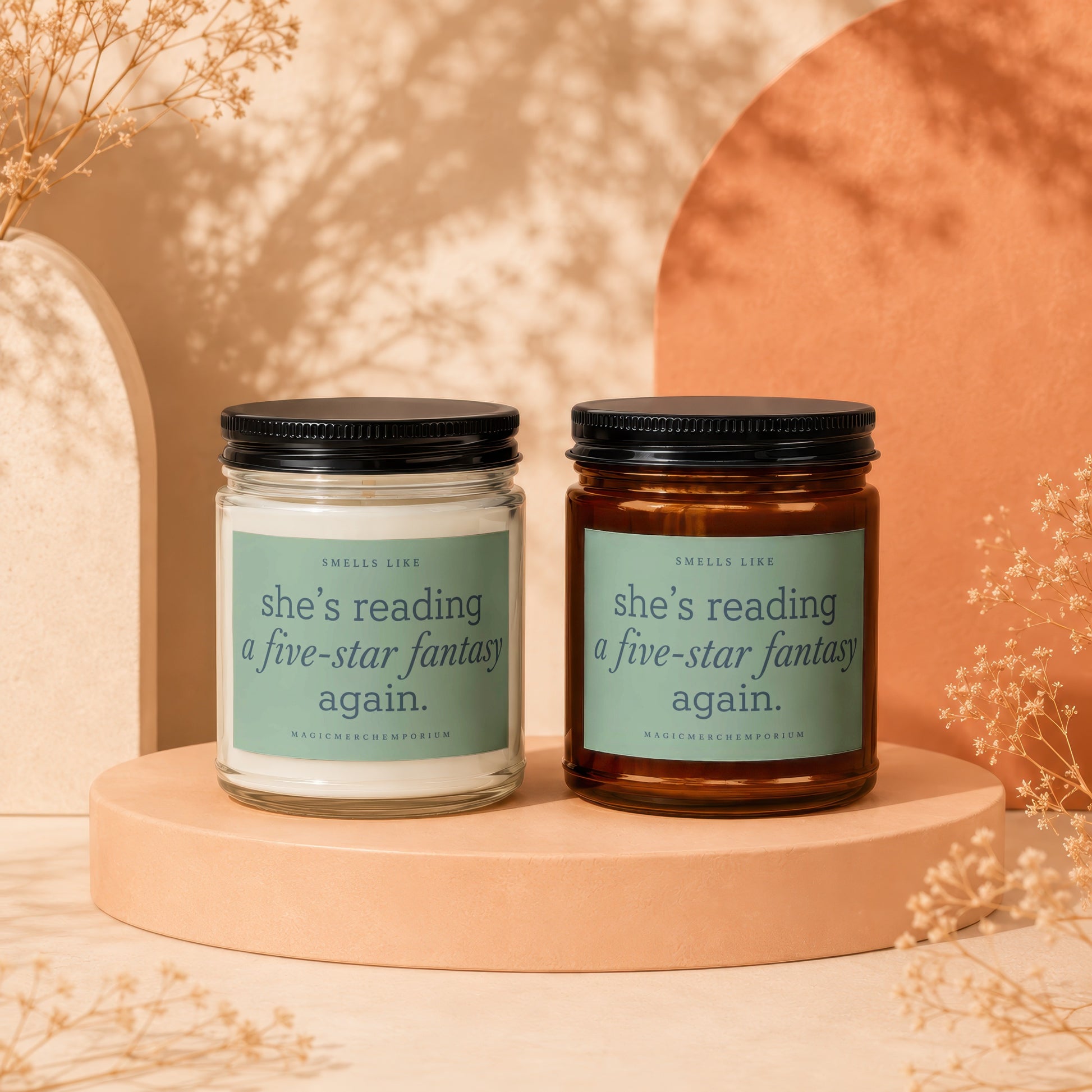 Two candles with labels that read: "Smells like she's reading a five-star fantasy again."