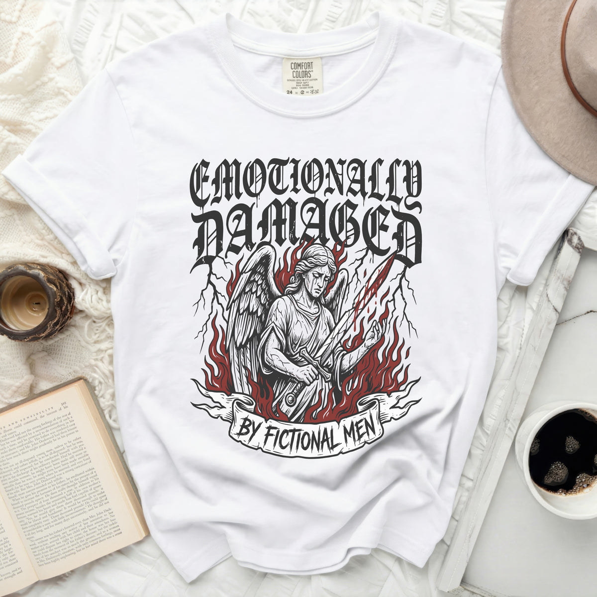 White t-shirt with graphic of an angel holding a bloody sword and "Emotionally Damaged By Fictional Men" text.
