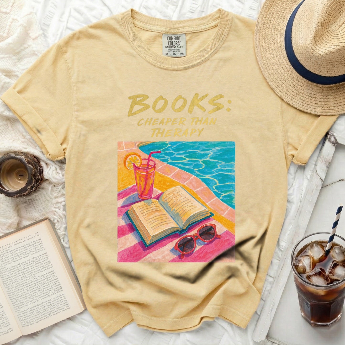 Yellow t-shirt with "BOOKS: CHEAPER THAN THERAPY" and poolside illustration.