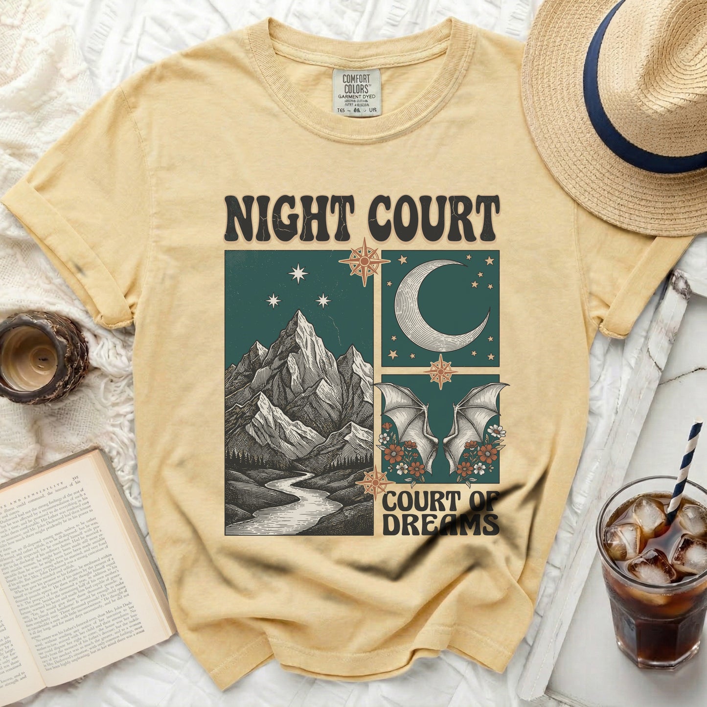 Yellow t-shirt with "Night Court" and "Court of Dreams" text and celestial mountain graphic.