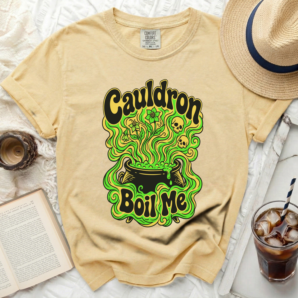Yellow Comfort Colors t-shirt with "Cauldron Boil Me" graphic and spooky elements.
