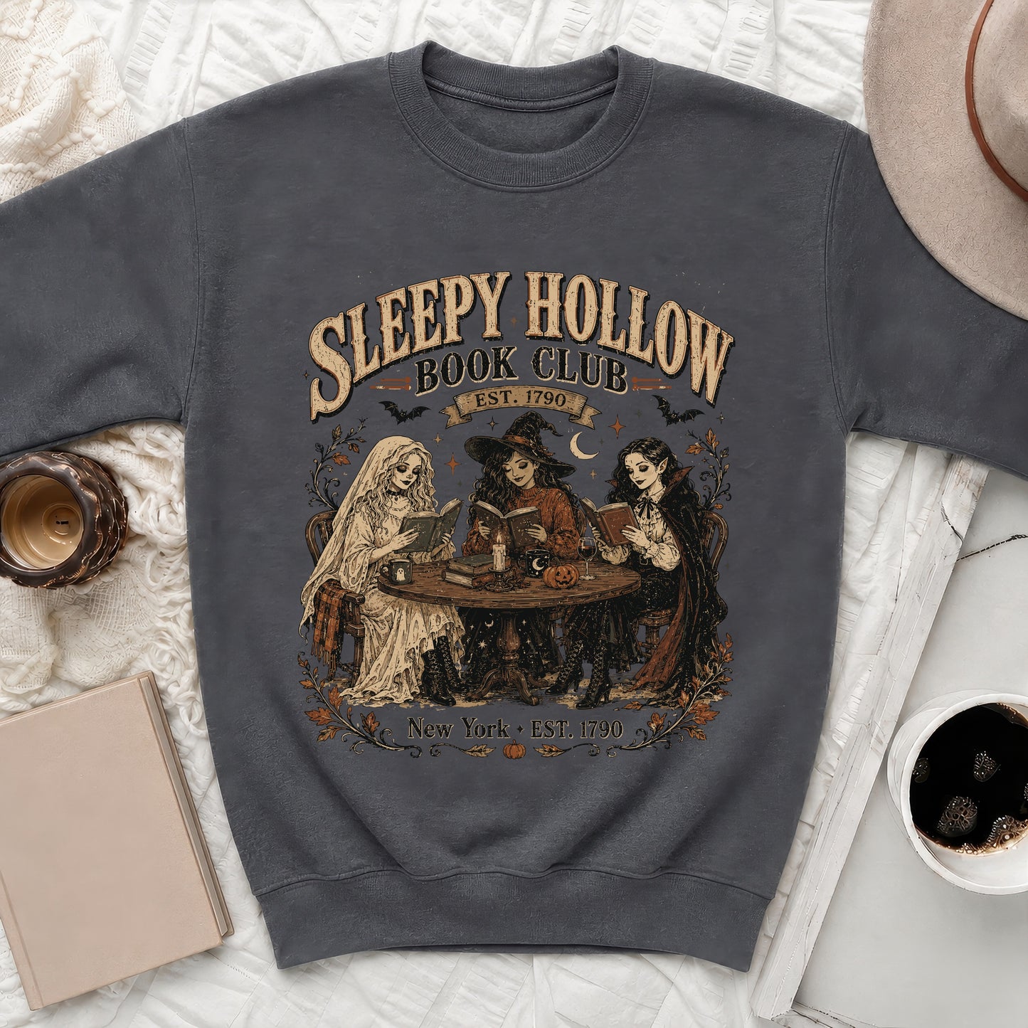 Sleepy Hollow Book Club graphic with three figures reading on a sweatshirt.