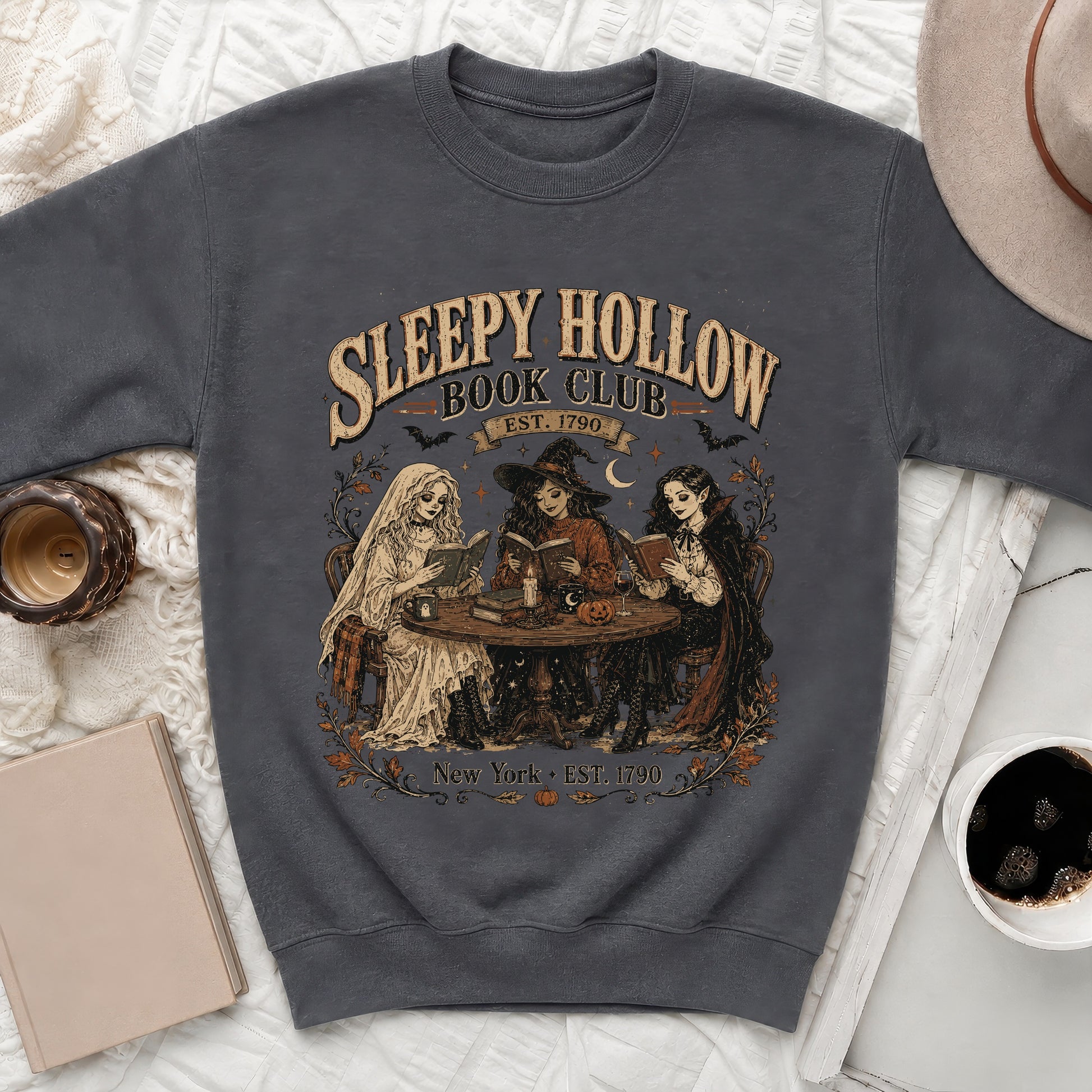 Sleepy Hollow Book Club graphic with three figures reading on a sweatshirt.