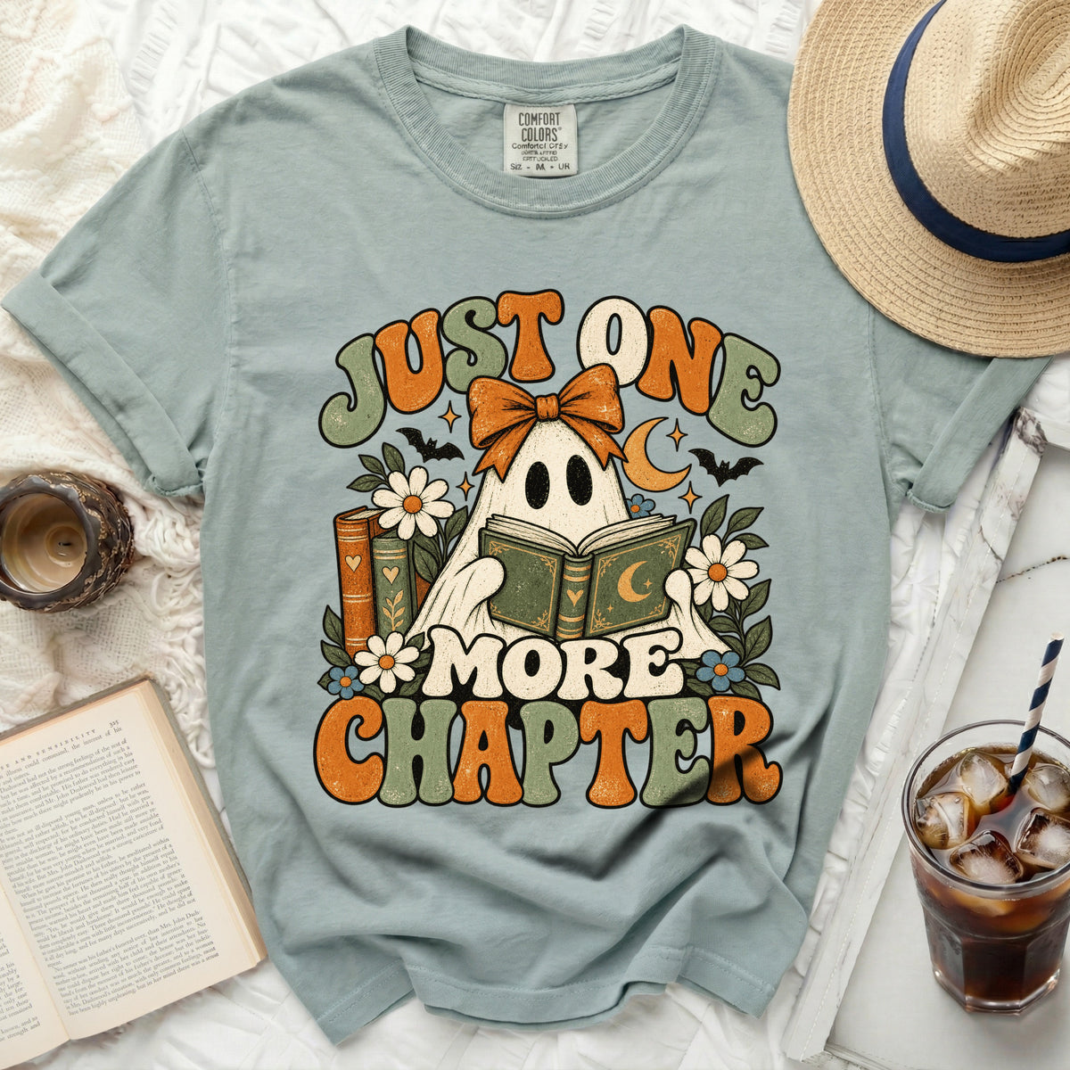 Ghost reading book graphic t-shirt with text "Just One More Chapter".