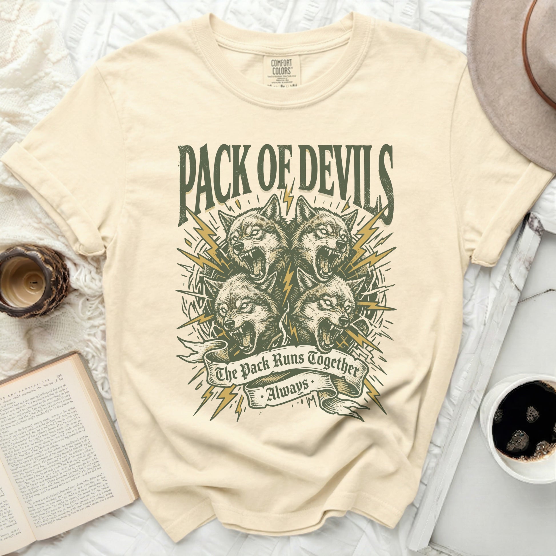 Cream t-shirt with "Pack of Devils" and wolf graphics.