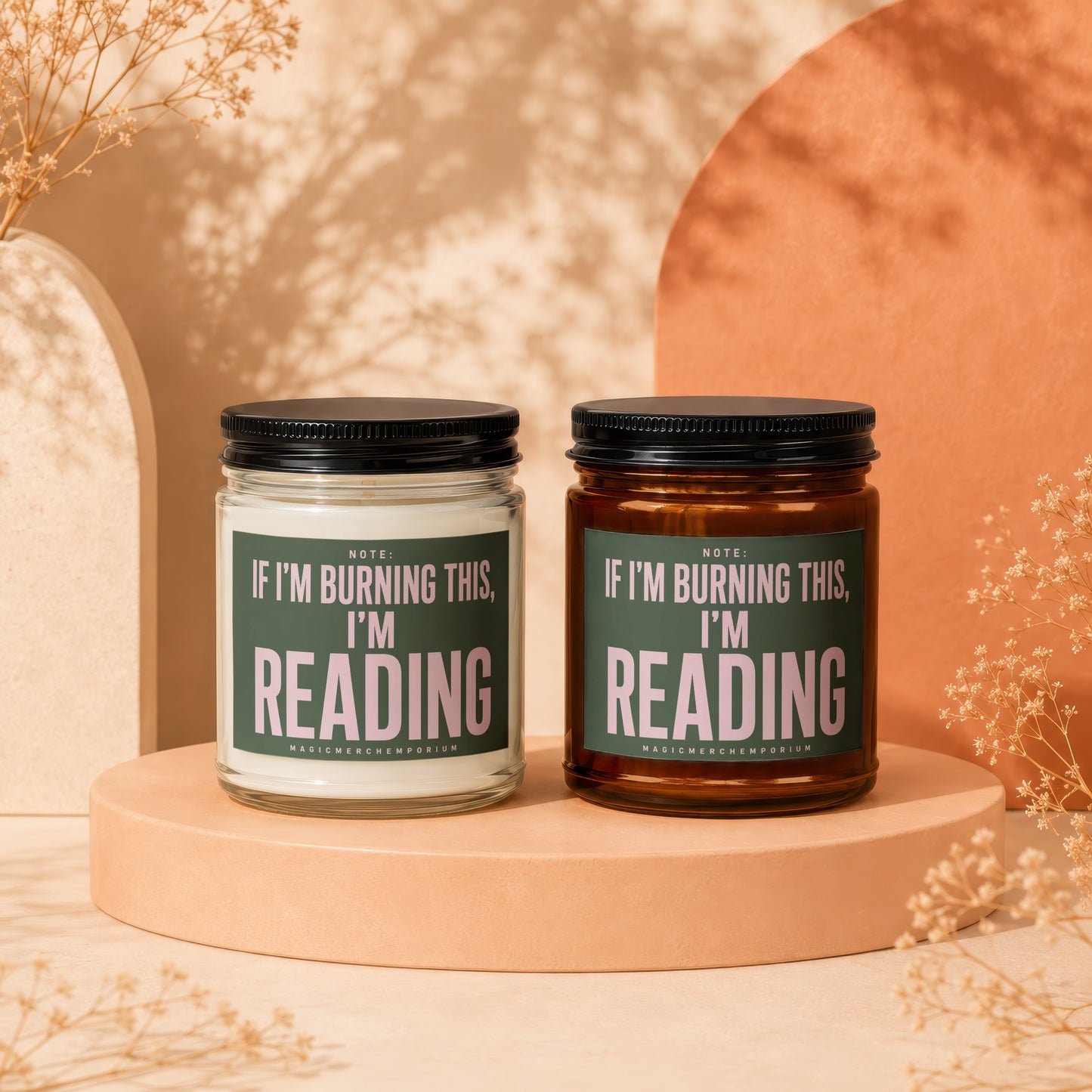 Two candles, one clear and one amber, with green labels reading "If I'm burning this, I'm reading."