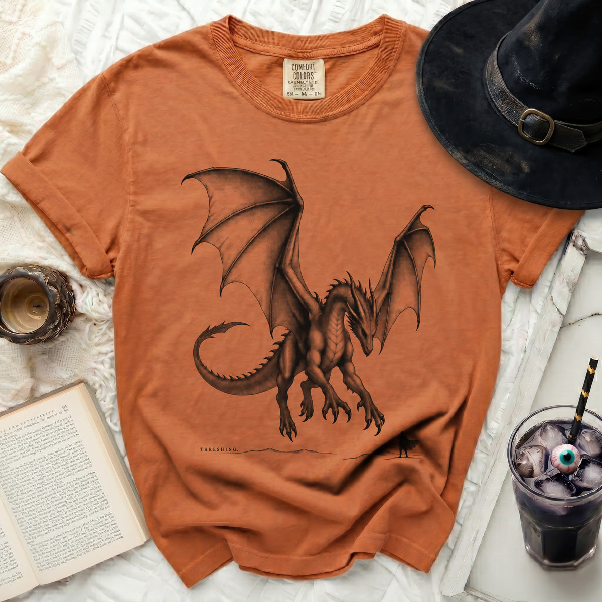 Orange Comfort Colors t-shirt with a charcoal drawing of a dragon and the text "THRESHING".