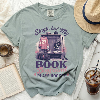 T-shirt with "Single but My Bookworm Plays Hockey" text and hockey gear.
