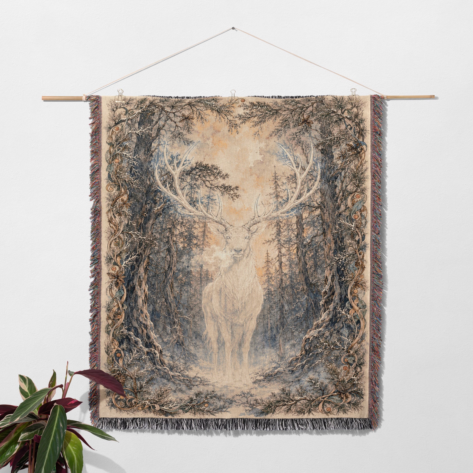a tapestry hanging on a wall, depicting a deer standing in a forest setting.