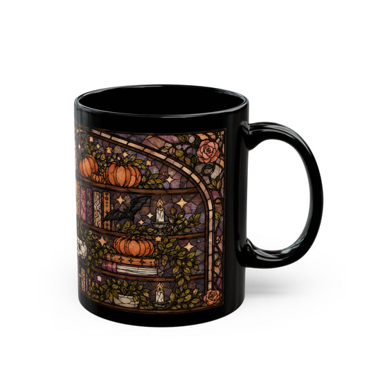 Black mug with stained glass design of pumpkins, books, a bat, and candles.