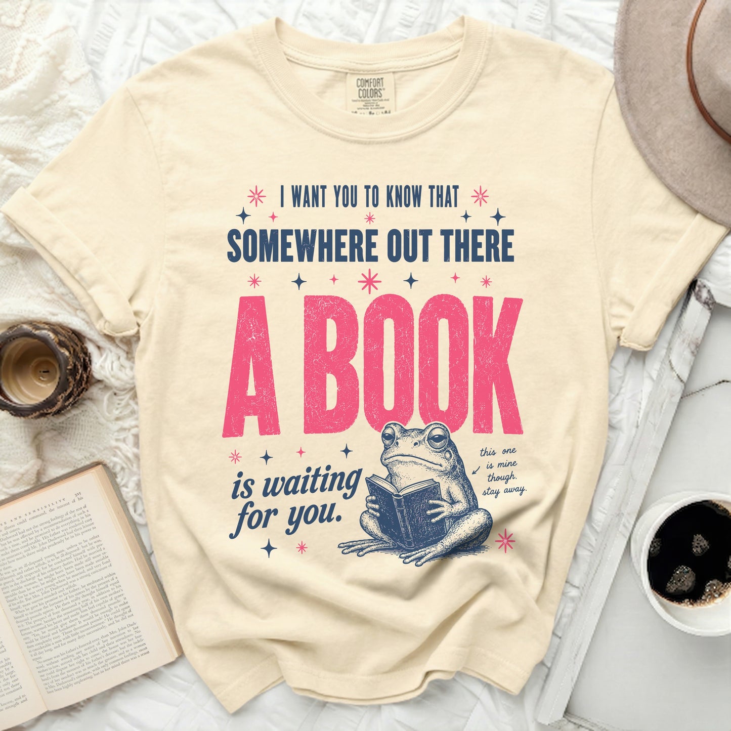 Cream t-shirt with frog reading a book and text "A BOOK is waiting for you."