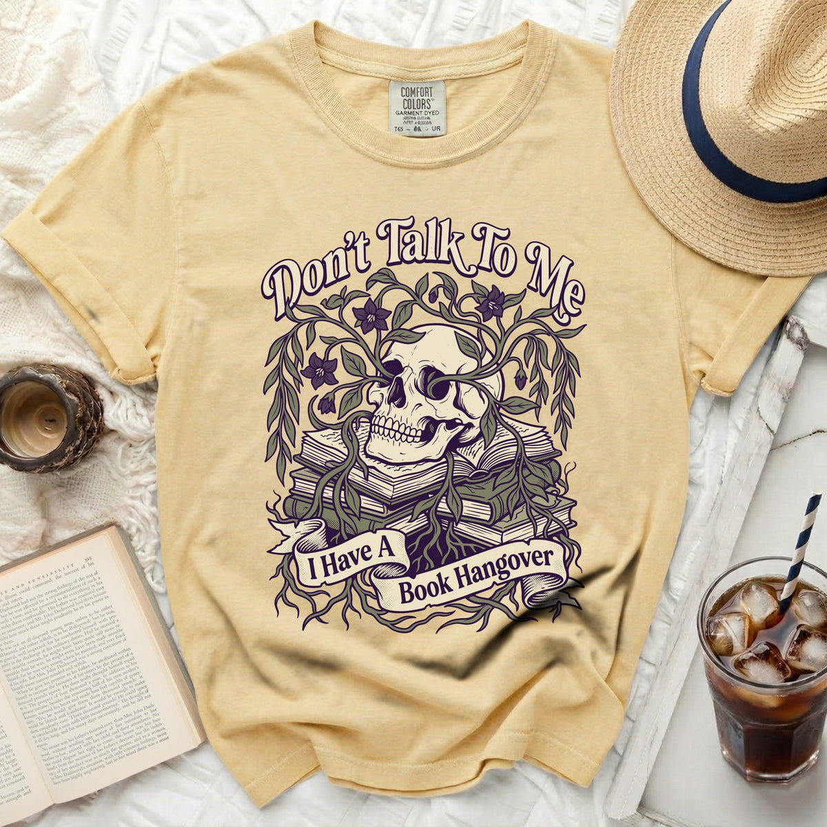 Yellow t-shirt with skull, books, and "Don't Talk To Me, I Have A Book Hangover" text.