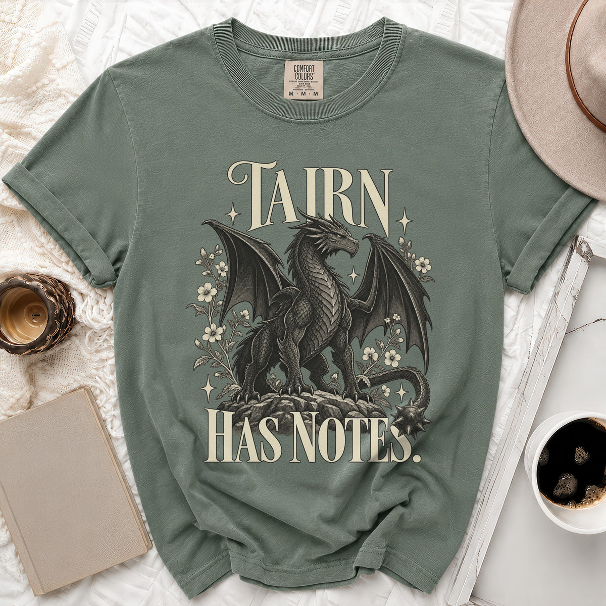 Green t-shirt with a black dragon design and text "TAIRN HAS NOTES."