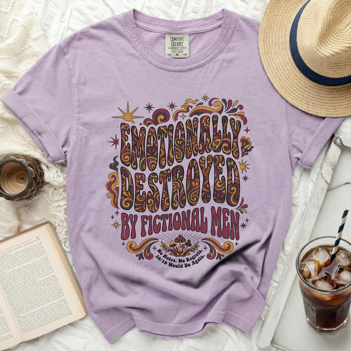 Purple t-shirt with "Emotionally Destroyed by Fictional Men" text and mushroom graphic.