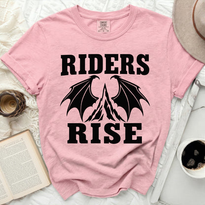 Pink t-shirt with black text and dragon wings graphic reading "RIDERS RISE"