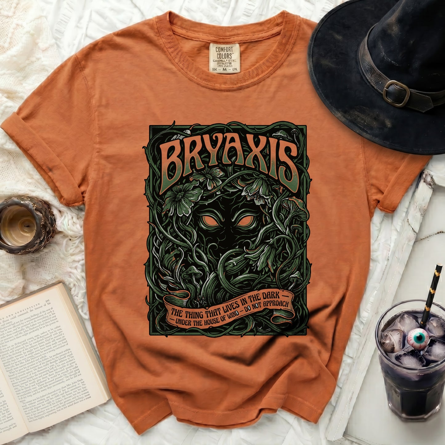 Orange t-shirt with "BRYAXIS" and a dark creature graphic.