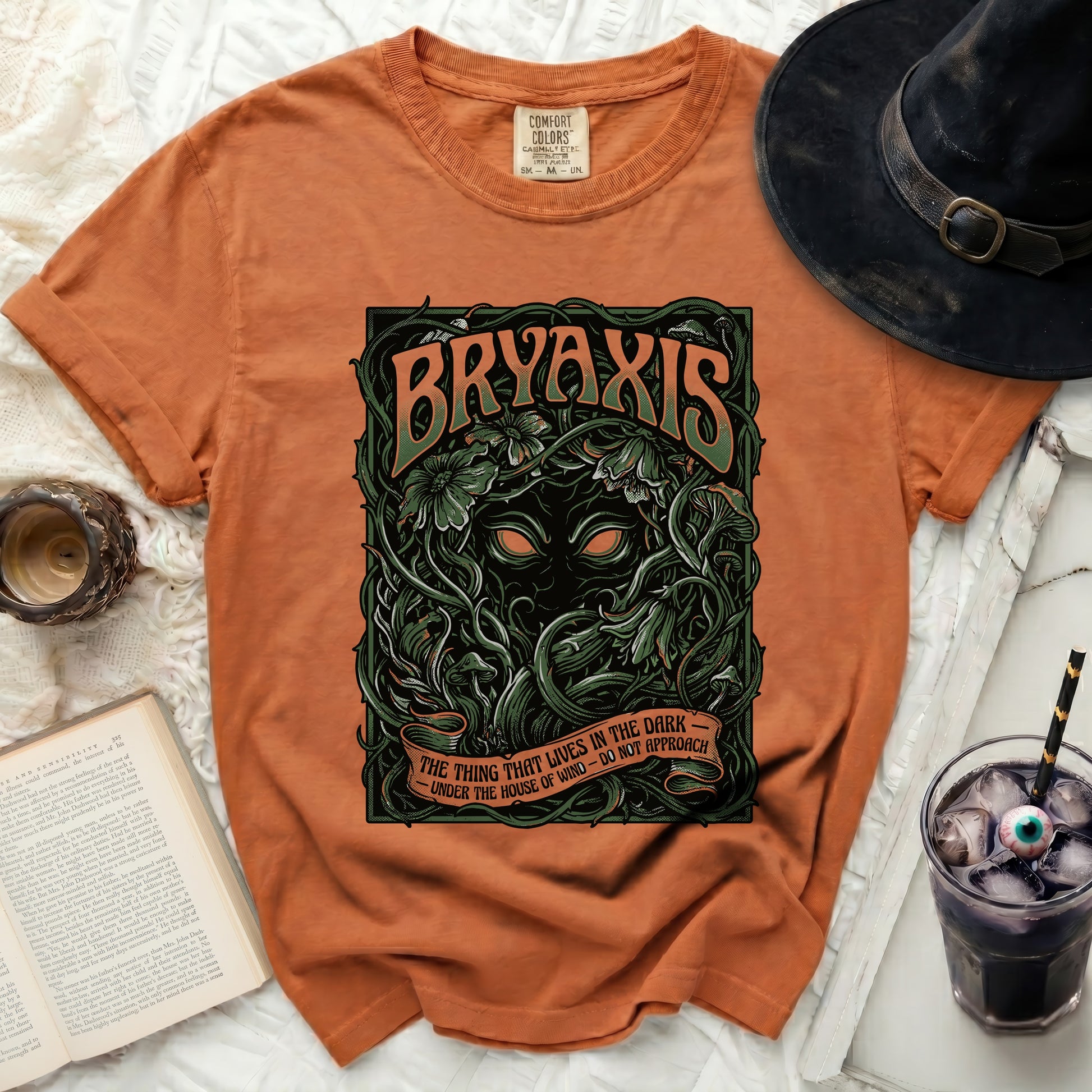 Orange t-shirt with "BRYAXIS" and a dark creature graphic.