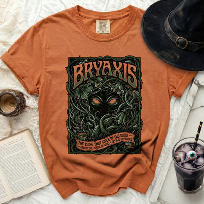 Orange t-shirt with "BRYAXIS" and a dark creature graphic.