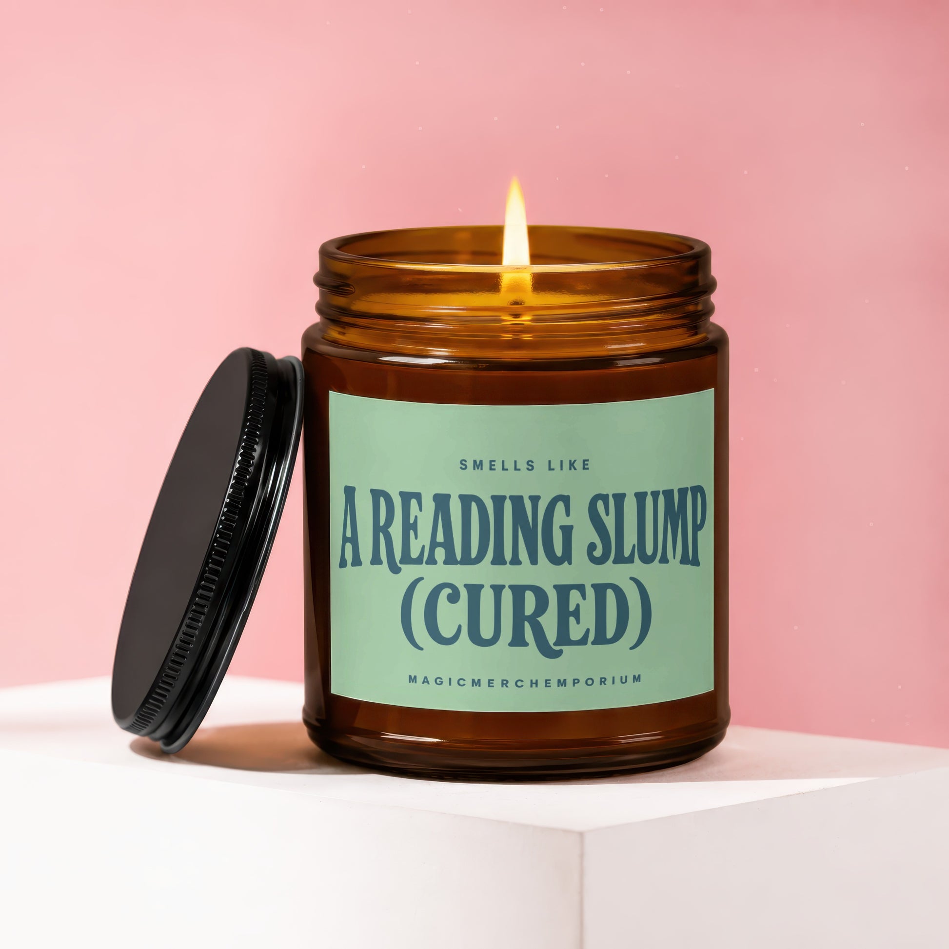 Amber candle with lit flame and black lid, reading "CREADING SLUMP (CURED)".