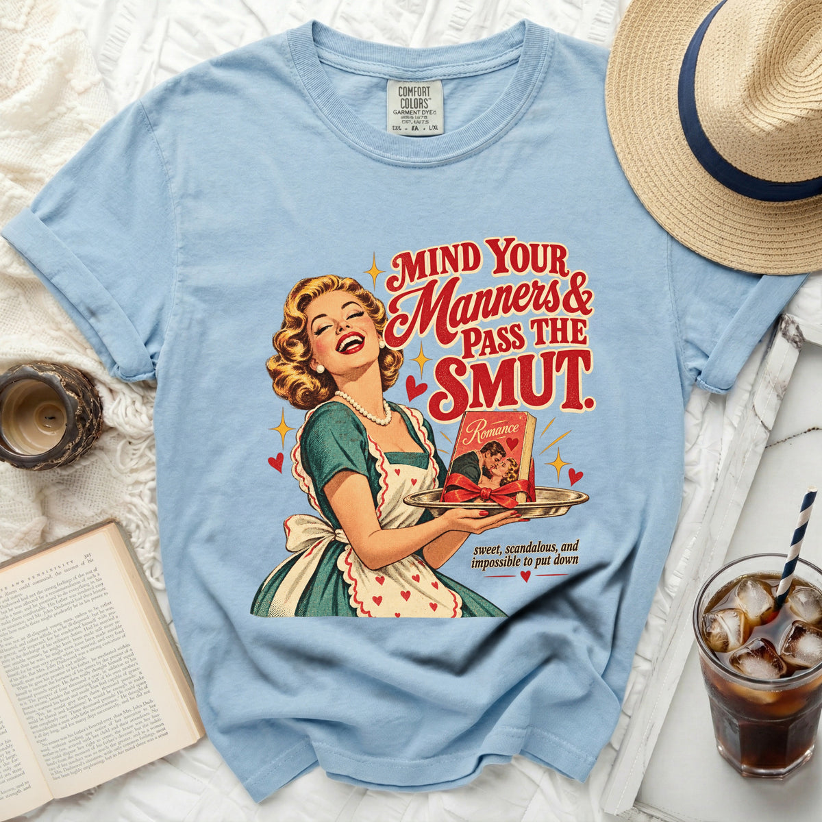 Light blue tee with vintage graphic: "Mind Your Manners & Pass the Smut".